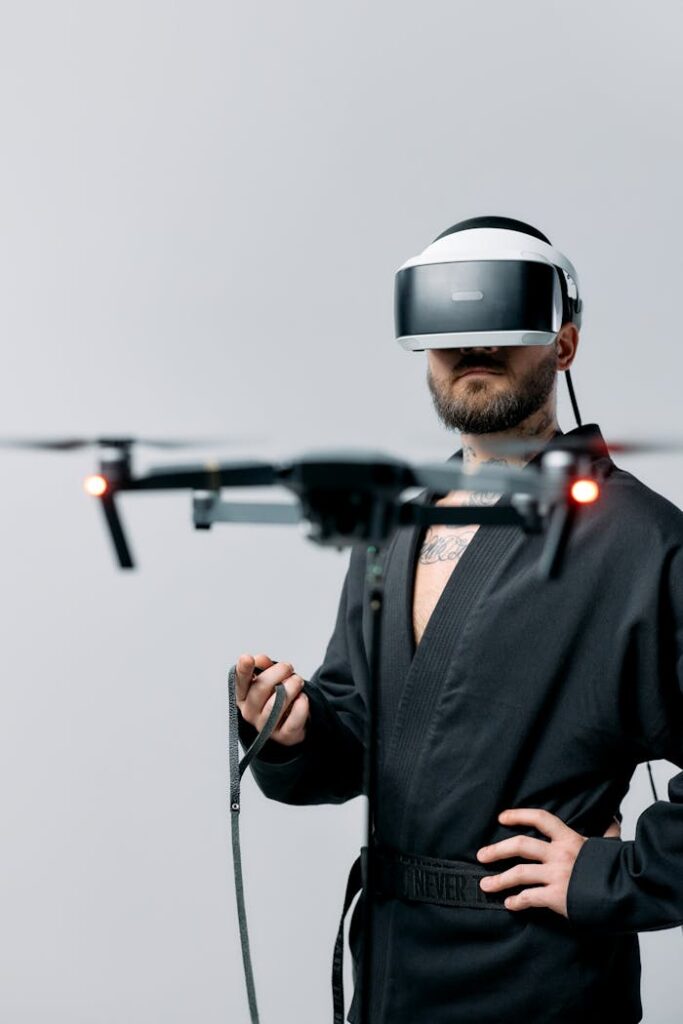 Man controlling a drone with virtual reality headset in a studio setting.